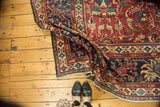 Corner of antique Persian Mahal carpet with intricate lotus, vinery border, and subtle patina.