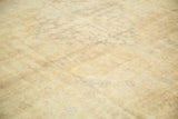 Distressed vintage Kaisary rug with textured foundation etching and soft ivory, pale gold tones.
