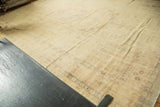 Distressed Turkish Kaisary rug corner, showing subtle tone-on-tone design and etching.