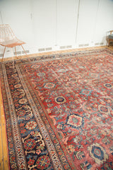 Vintage Mahal carpet's navy floral border and cherry red field with palmette motifs.