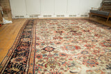 Antique Sultanabad carpet: allover ivory field, splayed palmettes, delicate tendrils, blush, navy, and oxidized green.