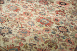 Antique Persian rug's splayed palmette pattern, softened pile, and muted red, blue, ivory hues.
