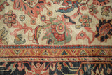 Antique Sultanabad carpet detail: ivory field, splayed madder red palmettes, and navy border.