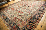 Antique Sultanabad rug corner: ivory field with splayed palmettes, tendrils, and navy border.