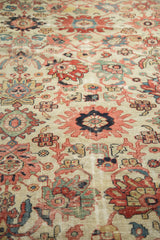 Antique Sultanabad rug's allover field with splayed palmettes and tendrils in ivory, blush, navy.