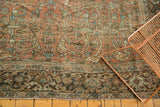 Distressed vintage Mahal detail: faded terra cotta field, sky blue vinery, sage green border.