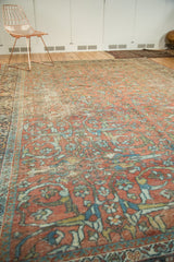 Distressed vintage Mahal rug texture with faded terra cotta, blue, gold, and green gol farang pattern.
