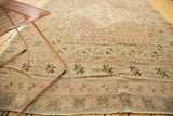 Vintage Oushak carpet corner with even wear, light foundation showing, and geometric border.