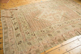 Corner detail of a Vintage Oushak carpet, showcasing geometric borders and faded floral field with even wear.