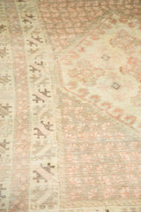 Visible wear with light foundation on vintage Oushak's blush floral and brown patterns.