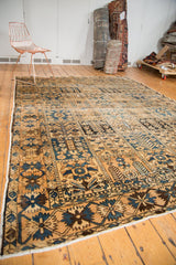 Hand-knotted Bakhtiari carpet with allover panel design, featuring blue, brown, and ivory stylized motifs.