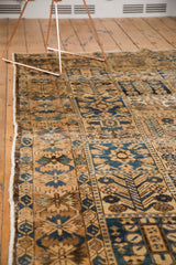 Vintage Bakhtiari carpet's intricate garden panel design in antique ivory, blue, and brown tones.