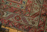 Worn pile texture of an antique Karabagh rug, showing madder red Herati mahi, ivory, blue motifs.