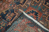 Vintage Karaja rug corner, revealing geometric navy, red, and green pattern, pile wear, and polychrome selvage.