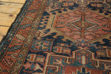 Vintage Karaja rug detail: geometric navy, red, gold pattern with polychrome selvage.