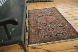 Geometric patterns and colors of a Vintage Karaja rug, showing polychrome selvage and ivory fringe.