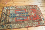 Geometric patterns, human figures, and rewoven foundation on an antique Caucasian prayer rug.