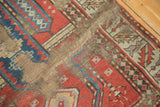 Cherry red and navy blue geometric patterns with professional rewoven foundation on an antique Caucasian rug.