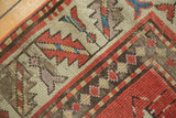 Antique Caucasian rug detail showing a human figure, rich red, and ivory geometric border.