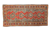 Antique Kazak runner with madder red geometric diamond medallions, muted blue field, 3'8