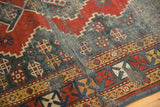 Antique Kazak rug runner with geometric madder red and teal patterns, visible foundation.