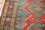 Caucasian Kazak runner's geometric border, madder red stepped motifs, and worn teal field.