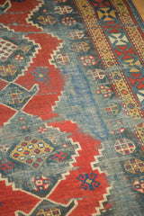 Visible foundation and madder red geometric patterns on an antique Kazak runner.