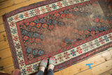 Antique Karabagh runner featuring allover boteh pattern, storied foundation wear, and polychrome selvage.