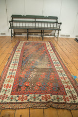 Antique Karabagh runner with allover staggered boteh pattern in madder red and indigo, showing isolated worn pile.