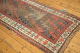 Corner of antique Karabagh runner, blue and red boteh field, polychrome selvage, storied wear.