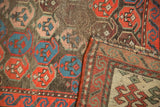 Antique Karabagh runner folded, revealing worn pile, multicolor selvage, and woven foundation.