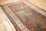 Antique Karabagh runner's polychrome selvage, geometric border, and worn boteh field.
