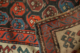 Antique Karabagh runner's geometric boteh pattern, hand-knotted foundation, and polychrome selvage.