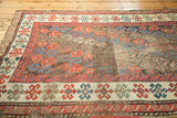 Antique Karabagh runner's field of staggered boteh motifs, madder red and blue, with visible patina.