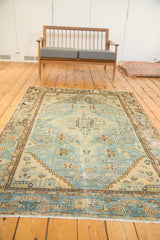Distressed Hamadan rug corner showing sky blue field, rectilinear motifs, and worn texture.