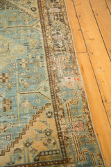 Distressed vintage Hamadan rug corner: worn sky blue field, brown rams horn border.