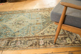 Distressed vintage Hamadan rug corner, dark chocolate border with rams horn and vine motif.