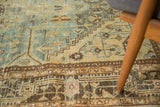 Distressed pile with sky blue, gold, and dark brown rectilinear patterns and subtle pink details.