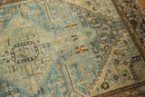 Distressed vintage Hamadan rug detail highlighting faded blue and sand tones with textured wear.