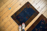 Antique Fette Li rug mat: bronze border, navy blue field, stylized wine red, raspberry florals, white fringe.