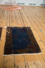 Antique Fette Li rug corner features Art Deco bronze border with intricate floral motifs.
