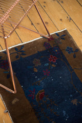 Antique Fette Li rug corner detail: navy blue field, bronze border, and curvilinear art deco florals.