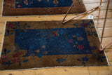 Art deco stylized floral details on an antique Fette Li rug's navy blue field and bronze border.