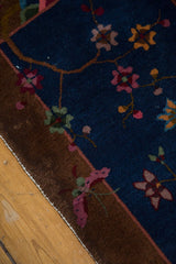 Antique Chinese Fette Li rug corner with Art Deco florals and deep cobalt field.