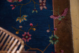 Art deco pink butterfly motif on copper border of Chinese Fette Li rug.