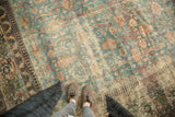 Distressed antique Persian Khorassan carpet with faded denim blue field, ivory scrolling palmettes.