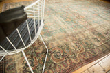 Distressed antique Khorassan rug, faded denim blue field, ivory scrolling vines, and Herati-inspired border.