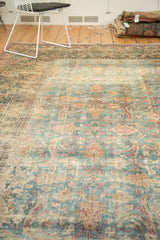 Distressed antique Khorassan carpet with faded blue, ivory, and red floral arabesque field.
