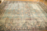 Distressed antique Khorassan carpet, faded denim blue field, scrolling vines, and visible wear.