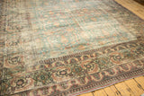 Distressed antique Khorassan rug border, Herati leaves, Mina Khani motif, faded blue field.